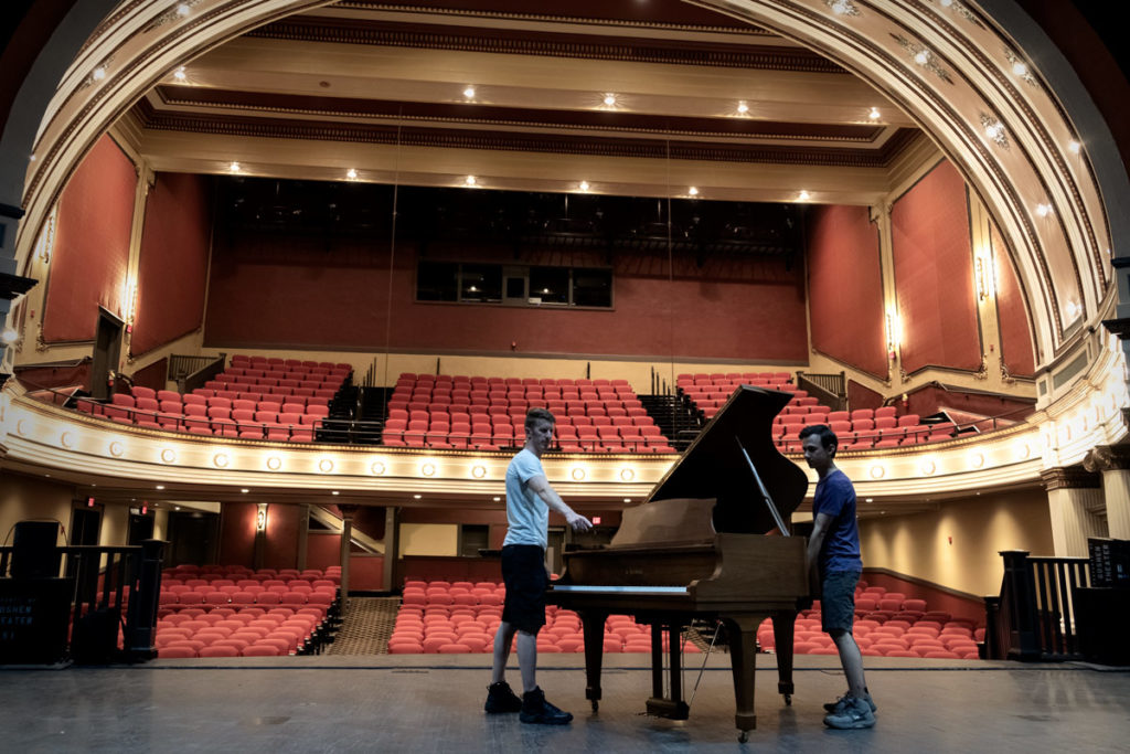 Tim & Peter placing a Kawai Grand Piano on stage at The Goshen Theater- Piano Moving Services by Chupp's Pianos